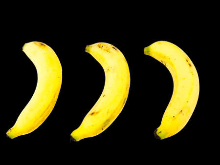 Ripe banana isolated on black backgroundの写真素材