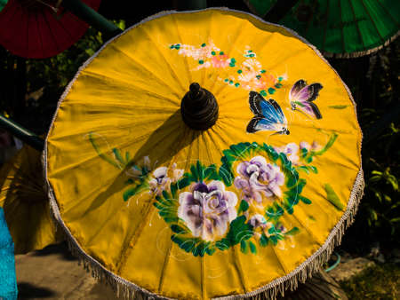 Yellow rice paper umbrella dried in nature. one of handmade souvenirs from Chiang  mai, Thailandの写真素材
