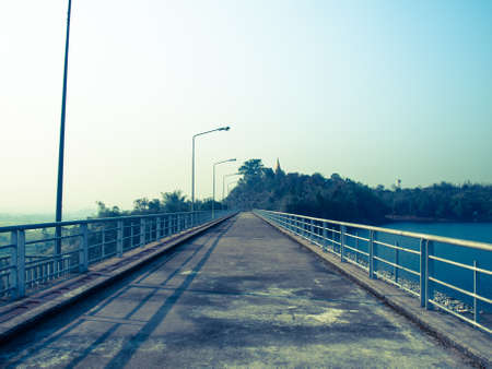 Cement road on lake in Chiang rai, Thailand: Filtered image:cross processed vintage effect.の写真素材