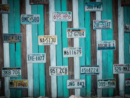 PRACHUAP KHIRI KHAN, THAILAND - FEB 23, 2015: Old US car registration plate on wooden wall in Hua Hin, Prachuap Khiri Khan, Thailand. retro styleのeditorial素材