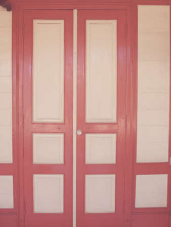 cream and red wooden door in vintage styleの写真素材