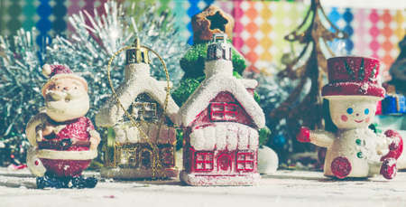 Santa Claus, snowman, houses & snow Sledge miniature model studio shot on colorful background for family, giving, season, Christmas, holiday, new year, travel and gathering conceptの写真素材