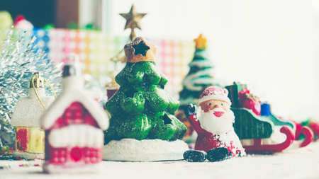 Santa Claus, houses & snow Sledge miniature model studio shot on colorful background for family, giving, season, Christmas, holiday, new year, travel and gathering conceptの写真素材