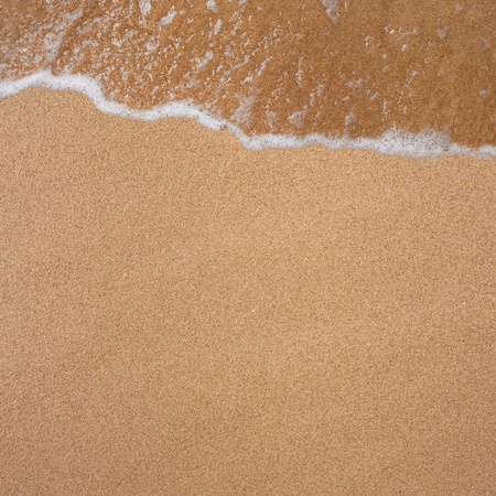 Natural background from the sand and waves on the beachの写真素材