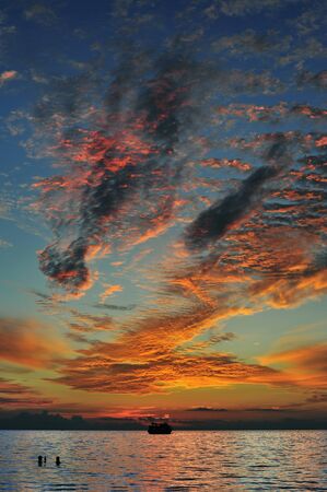 Figures in the sky - dramatic sunsetの写真素材