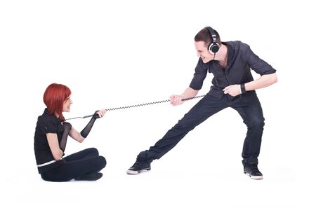 Two young people are playing with wire from the headphonesの写真素材