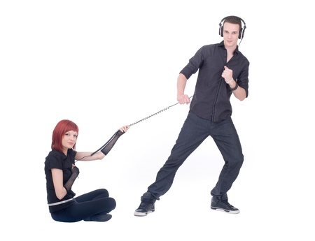 Two young people are playing with wire from the headphonesの写真素材