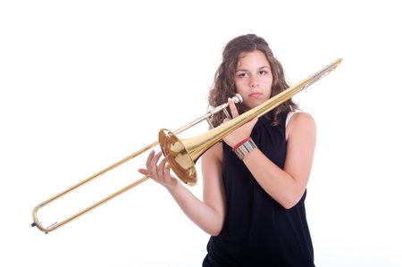 Teenage girl playing the trombone  Isolated on a white の写真素材