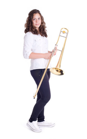 Teenage girl with trombone  Isolated on a white Studio shotの写真素材