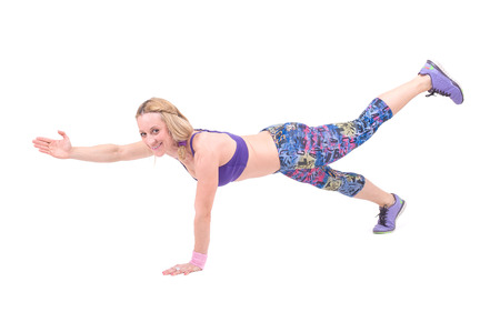 Sport young woman doing fitness exercise  Isolated on a white background  Studio shotの写真素材