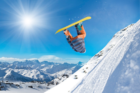 Extreme snowboarder jumping high in the air Extreme snowboarder jumping high in the air