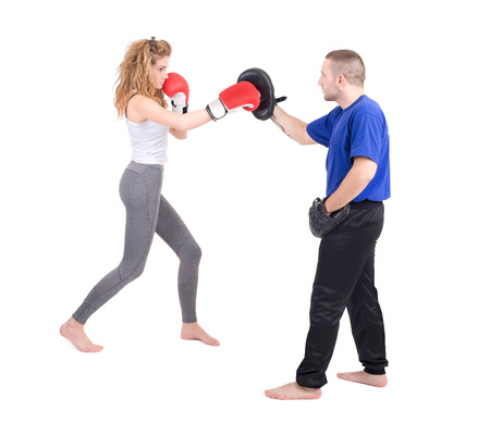 Kickboxing girl with trainer in sparring  Isolated on a white background  Studio shotの写真素材