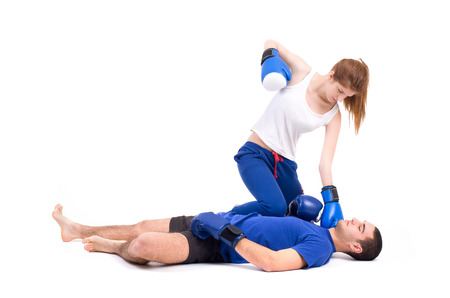 Boxing knockout  Girl knocked out man  Isolated on a white background  Studio shotの写真素材