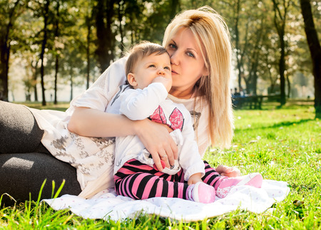 Mom and baby in nature on spring sunny dayの写真素材