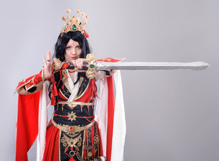 Wizard. Model dressed in renaissance style on gray background.の写真素材