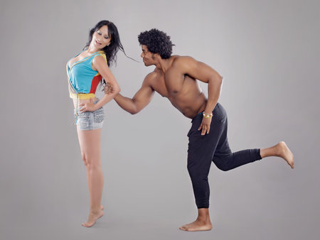 Passionate couple.  Young and sexy passionate couple on gray studio backgroundの写真素材