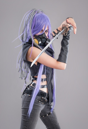 Female fantasy warrior. Female warrior with sword and gas mask isolated on the gray backgroundの写真素材