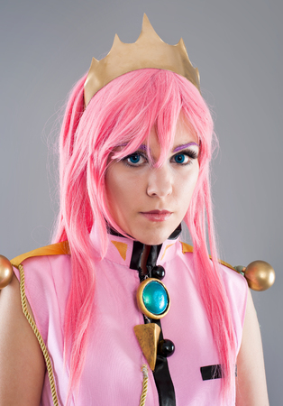 Princess in a pink dress isolated on the gray backgroundの写真素材