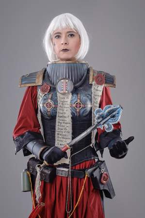 Woman warrior in battle armor. Isolated on the gray backgroundの写真素材