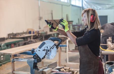 Female carpenter Using Circular Saw. Female carpenter Using Circular Saw for woodの写真素材