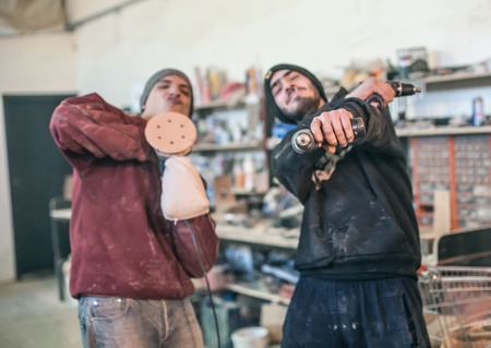 Funny Workers. Workers posing with their tools in the workshopの写真素材