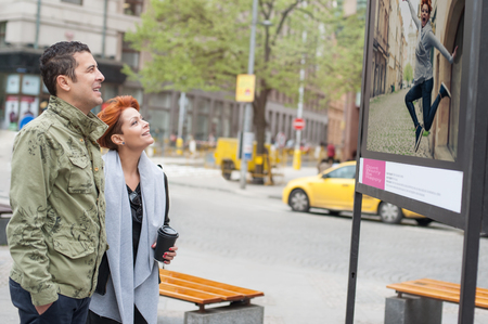 Couple tourist looking downtown contemporary street exhibition at leisure timeの写真素材