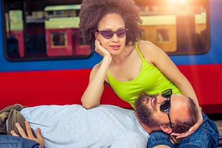 Beautiful couple backpacker tourist napping on a benchの写真素材