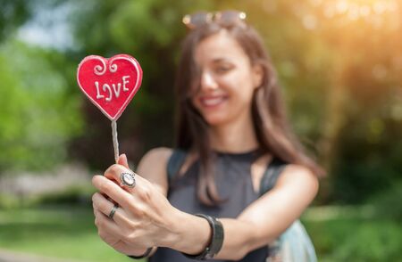 Portrait of pretty young woman with sweet lollipopの写真素材