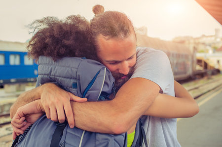 Man meeting his girlfriend from her trip at the train station. Close up.