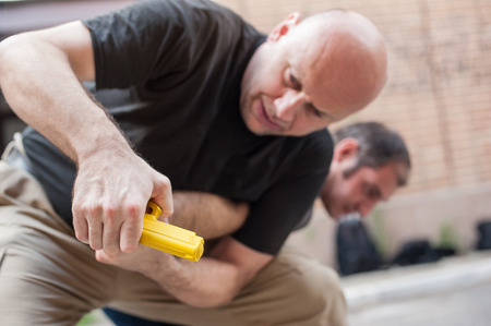 Kapap instructor demonstrates self defense techniques against a gun point. Gun Disarm.の写真素材