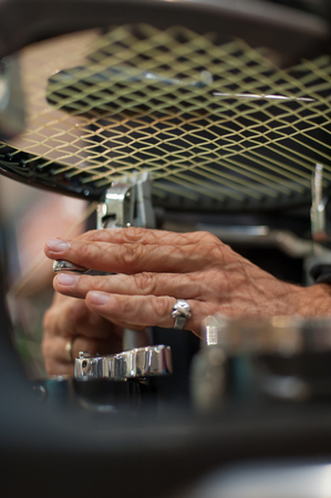 Stringing Machine. Close up of tennis stringer hands doing racket stringing in his workshopの写真素材