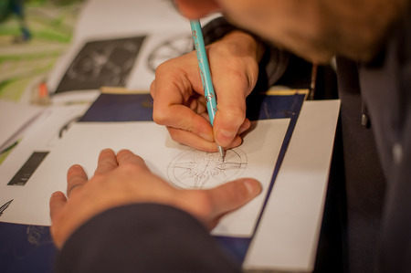 Tattoo artist drawing tattoo in his studioの写真素材