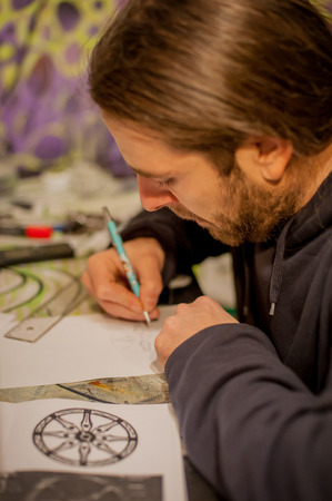 Tattoo artist drawing tattoo in his studioの写真素材