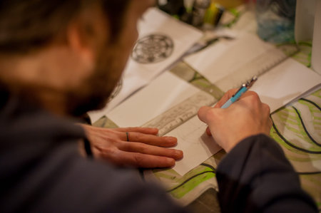 Tattoo artist drawing tattoo in his studio