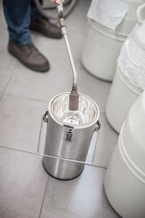 Liquid nitrogen technician fills cryogenic containerの写真素材