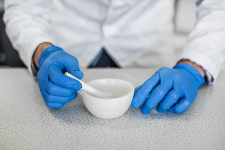 Chemist performs an experiment with liquid nitrogen in laboratory mortar with pestle