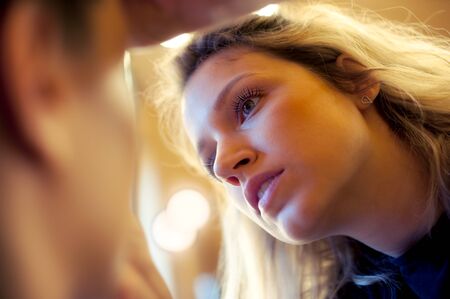 Makeup artist stylist applying eyeshadow on eyelid of womanの写真素材