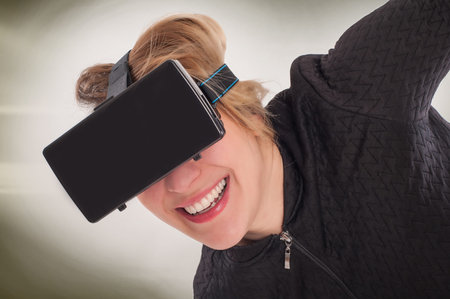 Woman play game with virtual reality device mask. Studio shoot.