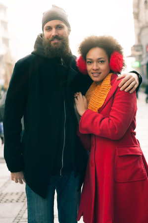 Portrait of romantic multiethnic couple in love hugging on the street. Valentines Day