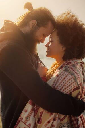 Romantic embracing loving couple enjoying the sunset in front of the city panorama. Falling in loveの写真素材