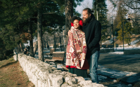Portrait of romantic multiethnic couple in love hugging on the street. Falling in love