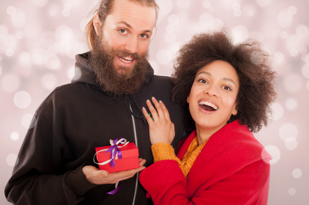 Beautiful young couple holding her gift box. I love youの写真素材