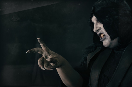 Spooky undead devil vamp with large scary nails. Hell and horror conceptの写真素材