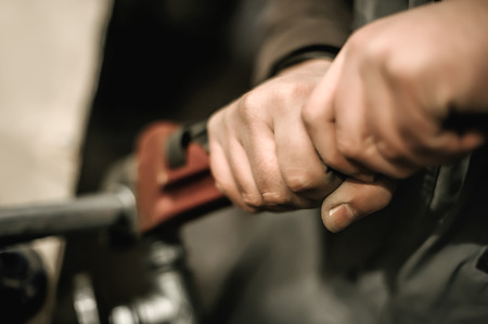 Carpenter using plier for his job in carpentry workshop. Close upの写真素材