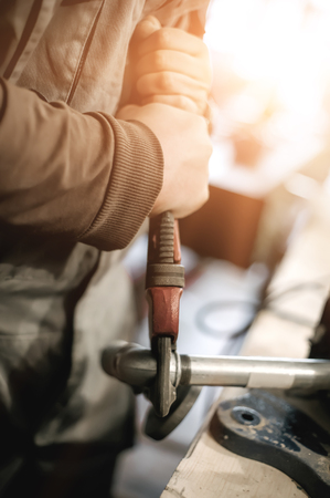 Carpenter using plier for his job in carpentry workshop. Close upの写真素材