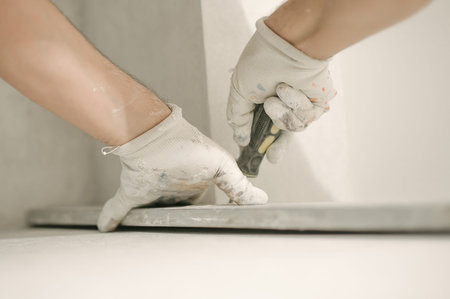 Construction worker using spirit level at home interior. Close up