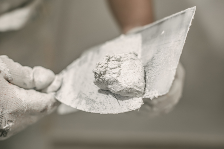 Construction mason worker with spatula and mortar. Construction toolsの写真素材