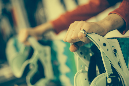 Snowboard repair shop worker adjust the bindings and equipment. Winter workshop serviceの写真素材