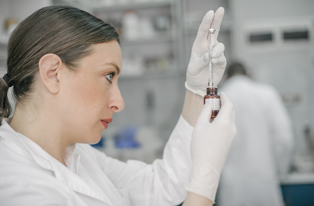 Young female doctor working in the laboratory. Close upの写真素材