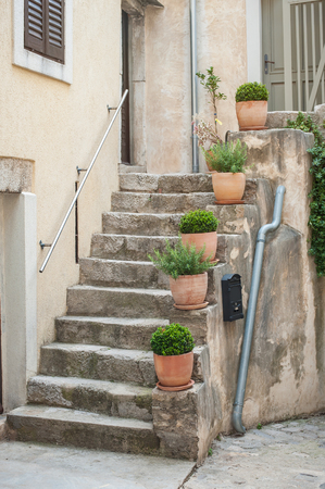 Stone stairs with flower pots in the mediterranean old townの写真素材